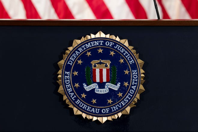 The FBI seal is seen before a news conference at FBI headquarters in Washington.