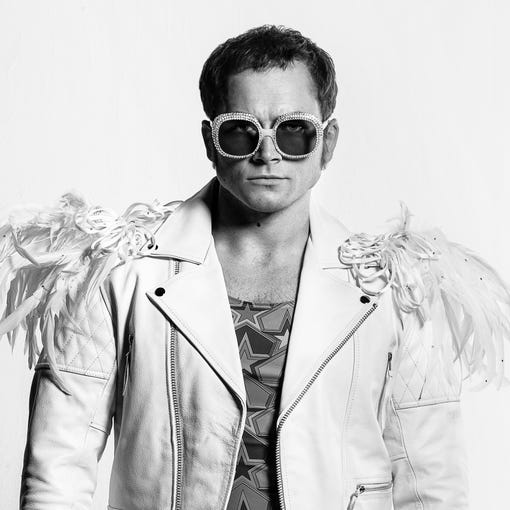 Taron Egerton wears a variety of Elton John's flamboyant looks playing the pop legend in the musical fantasy "Rocketman."