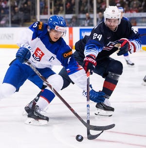 United States' Mattias Samuelsson, right, fights for control of the puck with Slovakia's Martin Fehervary during the third period on Wednesday.