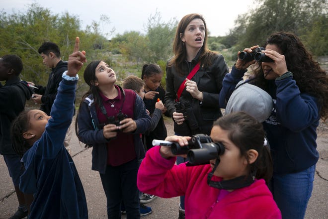 Emily Martell (back), a teacher/naturalist with the Nina Mason Pulliam Rio Salado Audubon Center, bird-watches with Zuri Rhooms (from left), 6, Johana Lugo, 10, Yhitzelle Bernal, 8, and other kids from the Tri-City West Thornwood Branch of Avondale of the Boys & Girls Clubs of Metro Phoenix, at the Audubon Center in Phoenix on Dec. 6, 2018. "Arizona's River Keepers" is an after-school program for third- through sixth-graders to expose them to the different plants and animals in the Salt River area just south of downtown Phoenix. It is a Season for Sharing grant recipient.