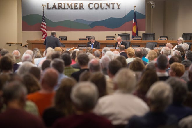 People pack a room as Larimer County Commissioners hear public comment during a hearing to permit or deny a proposed water pipeline for the City of Thornton on Tuesday, July 23, 2018. 