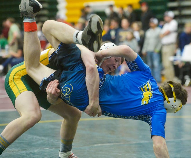 CMR's Carter Carroll lifts Great Falls Central's Lars Madson during the CMR Holiday Classic Wrestling Tournament in the Russell Fieldhouse last December.