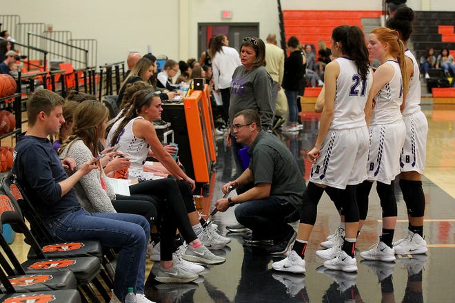 Benjamin’s coach’s Cody Propps and Mindy Myers talks to the Lady Stangs during a timeout Friday as the Rider Raiders took on the Benjamin Lady Stangs  in the Union Square Lady Bulldog Christmas Classic in Burkburnett.