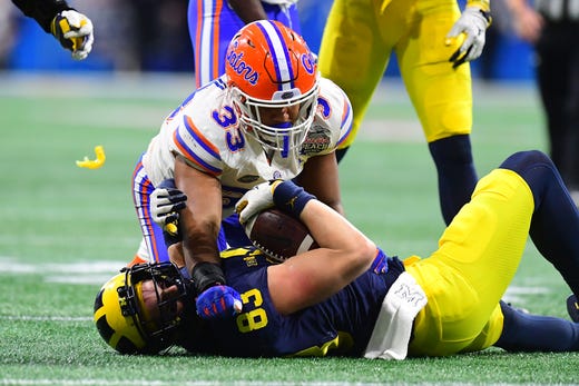 Michigan tight end Zach Gentry is tackled by Florida's David Reese II in the third quarter during U-M's 41-15 loss in the Peach Bowl on Saturday, Dec. 29, 2018, in Atlanta.