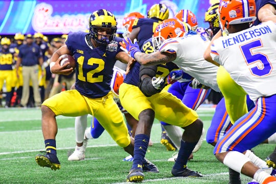 Michigan Wolverines' Chris Evans runs the ball against the Florida Gators in the fourth quarter of the Peach Bowl at Mercedes-Benz Stadium on Dec. 29, 2018 in Atlanta.
