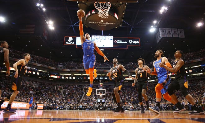 Oklahoma City Thunder guard Russell Westbrook drives to the basket and scores against the Phoenix Suns on Dec. 28 at Talking Stick Resort Arena in Phoenix.