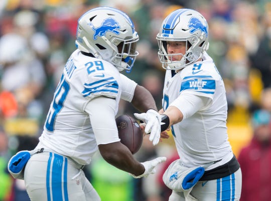 Lions quarterback Matthew Stafford hands the football off to running back LeGarrette Blount during the first half on Sunday, Dec. 30, 2018, in Green Bay, Wis.