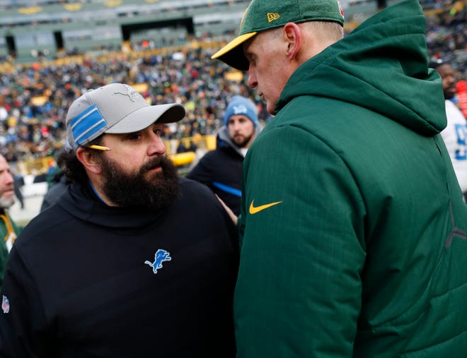 Lions head coach Matt Patricia talks to Packers head coach Joe Philbin after the game.