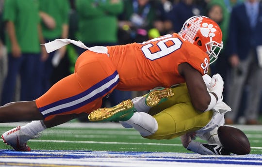 Clemson defensive lineman Clelin Ferrell (99) brings down Notre Dame quarterback Ian Book (12) during the 1st quarter of the Goodyear Cotton Bowl at AT&T stadium in Arlington, TX Saturday, December 29, 2018.