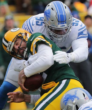 Detroit Lions defensive end Romeo Okwara (95) sacks Green Bay Packers quarterback Aaron Rodgers (12) during the first quarter of their game Sunday, December 30, 2018 at Lambeau Field in Green Bay, Wis.

MARK HOFFMAN/MILWAUKEE JOURNAL SENTINEL