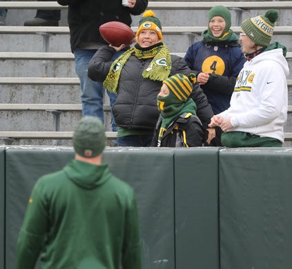 Fans play catch with Green Bay Packers quarterback Tim Boyle (8) before the game against the Detroit Lions at Lambeau Field Sunday, December 30, 2018 in Green Bay, Wis.