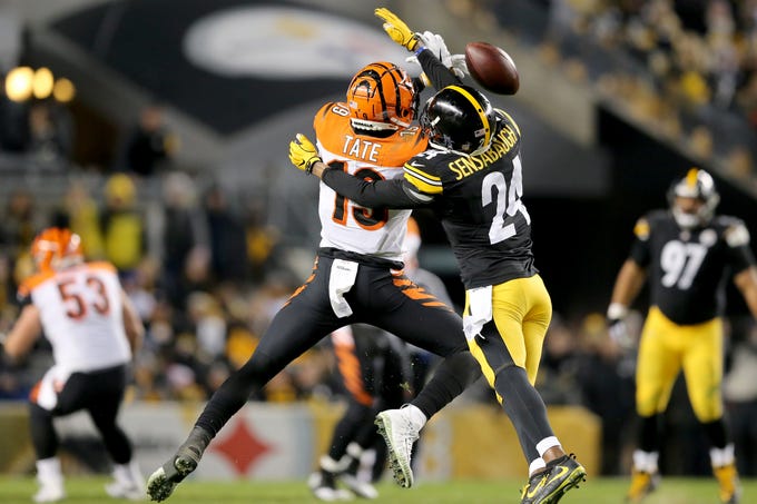 Cincinnati Bengals wide receiver Auden Tate (19) is unable to complete a catch as Pittsburgh Steelers cornerback Coty Sensabaugh (24) defends in the fourth quarter of a Week 17 NFL football game, Sunday, Dec. 30, 2018, at Heinz Field in Pittsburgh. The Cincinnati Bengals lead 10-3 at halftime. The Pittsburgh Steelers won 16-13. 