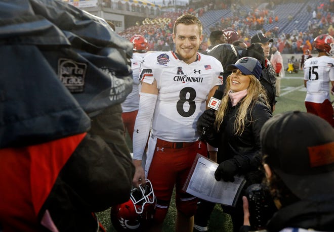 Cincinnati Bearcats quarterback Hayden Moore (8) smiles as he's interviewed by ESPN after the fourth quarter of the Military Bowl at Navy–Marine Corps Memorial Stadium in Annapolis, Md., on Monday, Dec. 31, 2018. The Bearcats took home the Military Bowl trophy and complete the team's third-ever 11-win season.