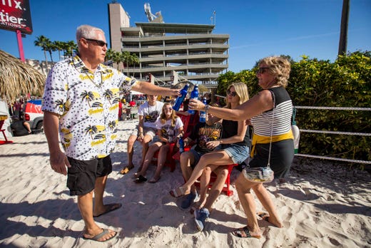 Bill and Cyndee Kusy of Urbandale, right, tailgate outside Raymond James Stadium with their family Jan. 1, 2019 in Tampa, Florida, before Iowa takes on Mississippi State in the Outback Bowl.