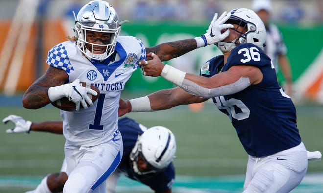 Kentucky Wildcats wide receiver Lynn Bowden Jr. (1) stiff arms Penn State Nittany Lions linebacker Jan Johnson (36) during the second half in the 2019 Citrus Bowl at Camping World Stadium.