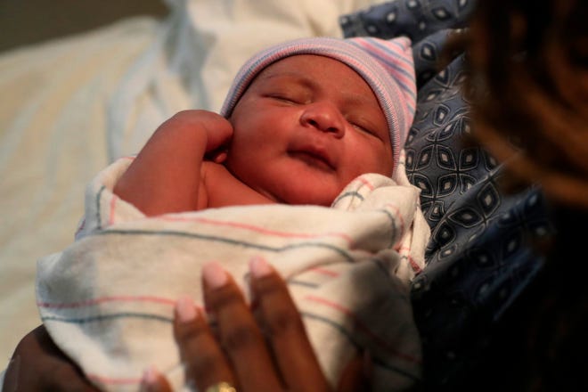 Zen Marie Barber sleeps in her mother's arms just hours after her birth. Zen Marie was born at 12:04 a.m. on New Year's Day at Tallahassee Memorial HealthCare to Britney Johnson and Wallace Barber.