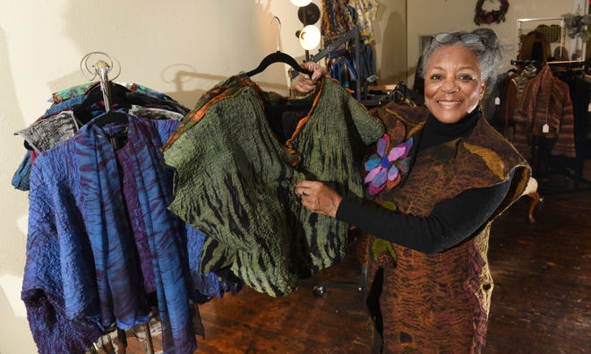 Curvie Jones, owner of Curvie's Hats, Etc., shows various Shibori jackets at her Ferndale store on Woodward Avenue.