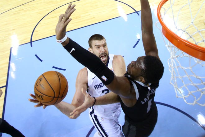 Grizzlies center Marc Gasol tries to lay the ball up past Pistons guard Reggie Jackson during their game Wednesday at FedExForum.