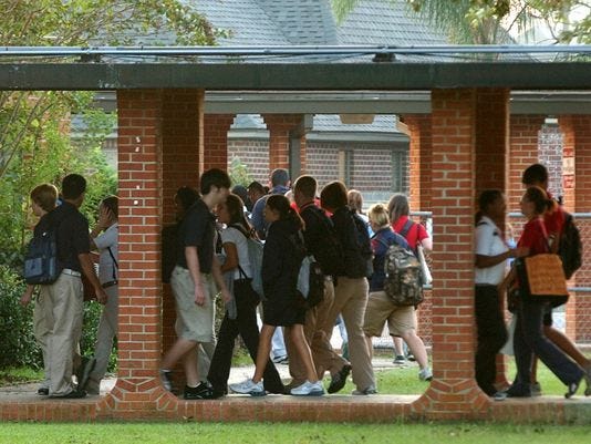 Students walk through the Comeaux High campus.