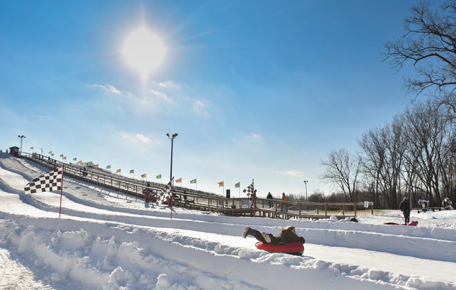 Snow-tubers hit the hill on opening day at Hawk Island County Park in Lansing, Thursday, Jan. 3, 2019.  It features sculpted runs, and a lift to the top of the hill.