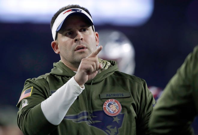 New England Patriots offensive coordinator Josh McDaniels wears green as part of the Salute to Service military appreciation campaign before an NFL football game between the Patriots and the Green Bay Packers, Sunday, Nov. 4, 2018, in Foxborough, Mass. (AP Photo/Charles Krupa)