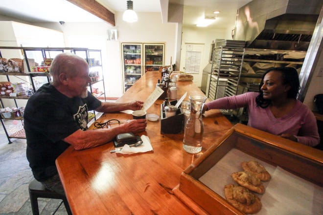 Dick Hartley, 68, from Garner Valley, stops by the reopened Sugarloaf Cafe for a coffee and is served by Tara Spehar, of Idyllwild on January 4, 2019, in Pinyon Pines. Hartley remembers first going to The Sugarloaf Cafe when he was 10 years old. The historic cafe is located along Highway 74 in Pinyon Pines.