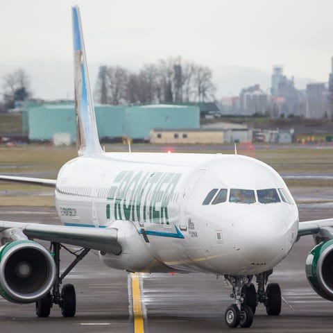 A Frontier Airlines Airbus A321 taxis to Gate D4...