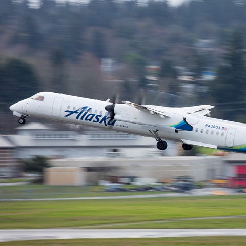 An Alaska Airlines Bombardier Q400 takes off from...