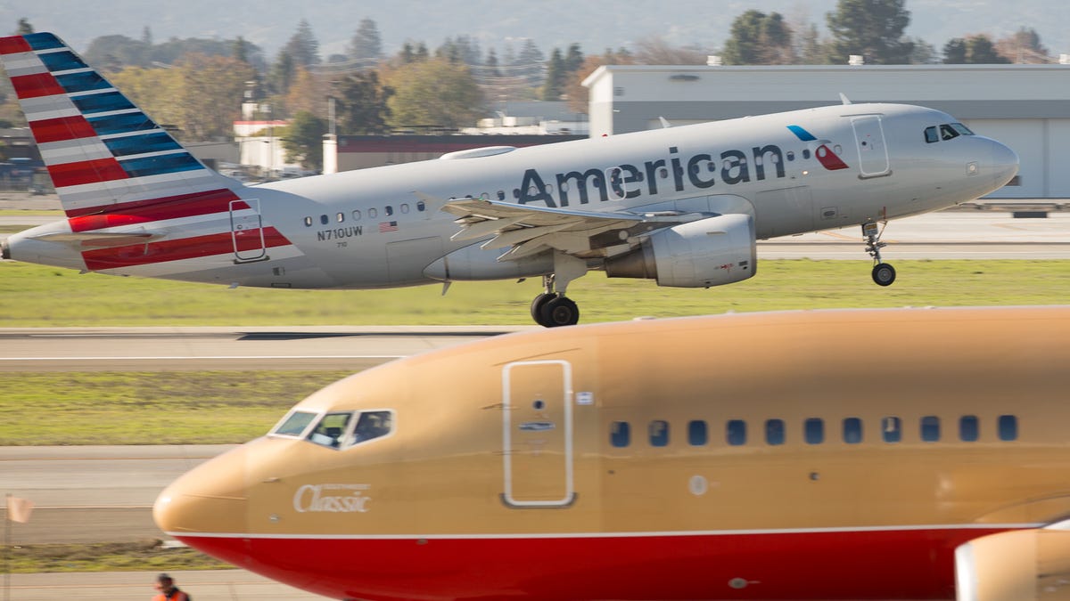 An American Airlines Airbus A319 takes off from San Jose International Airport while a Southwest Airlines Boeing 737-700 is set to depart in December 2018.
