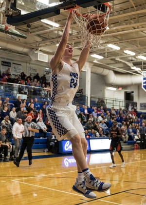 Chillicothe junior Brandon Noel hangs off the rim after dunking the ball to score for Chillicothe Saturday night at Chillicothe High School. Chillicothe defeated Waverly 71-40. 