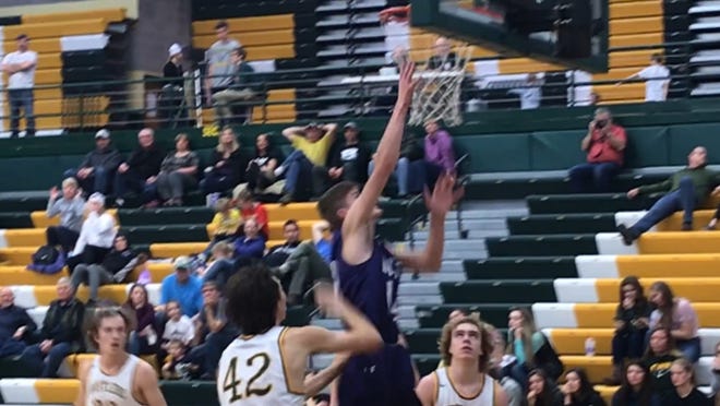 Butte High's Trevyn Roth goes past CMR's Russell Gagne for a layup during Saturday's Eastern AA game at CMR.