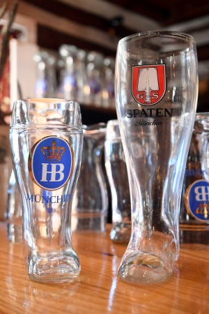 Boot glasses for beer sit on the bar at the Bavarian Restaurant & Biergarten. 