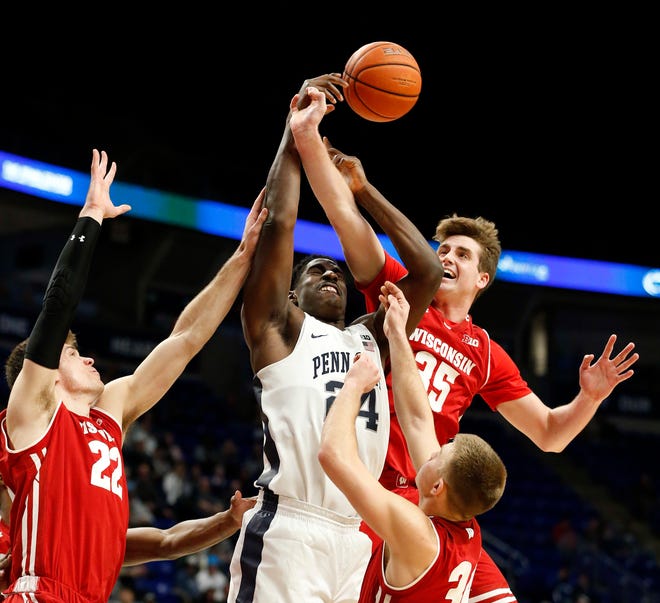 Wisconsin's Nate Reuvers (35) fights for a rebound against Penn State's Mike Watkins (24) during second-half action.