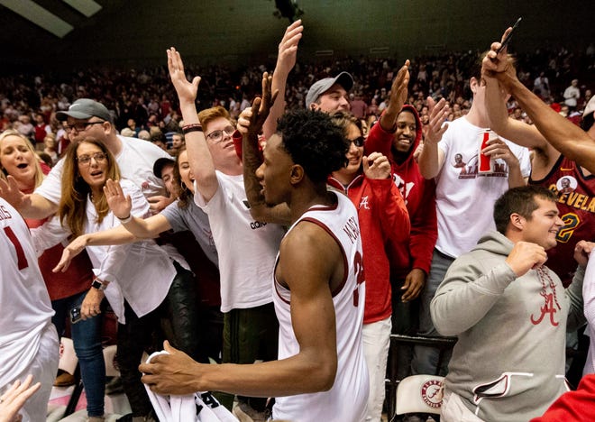 Alabama guard/forward Tevin Mack (34) celebrates with fans after a 77-75 upset win over Kentucky on Saturday.
