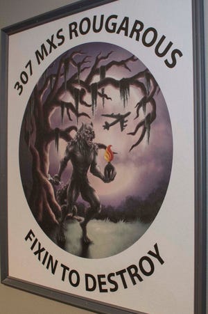 The Rougarou, a mythical werewolf popular in Cajun folklore, hangs on display in a painting created by U.S. Air Force Staff Sgt. Ashley Johnson for the 307th Maintenance Squadron at Barksdale Air Force Base, Louisiana.  The Rougarou serves as the mascot for the unit. A Reserve Citizen Airman, Johnson has used her talent as an artist to create similar paintings for other units in the 307th Bomb Wing.  (U.S. Air Force photo by Master Sgt. Ted Daigle)