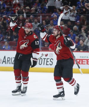Coyotes' Alex Galchenyuk (17) and Conor Garland (83) celebrate a goal from Nick Cousins against the Rangers during the second period at Gila River Arena in Glendale, Ariz. on January 6, 2019.