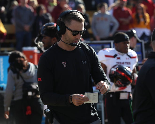 Texas Tech Red Raiders head coach Kliff Kingsbury looks at his notes during their game against the Iowa State Cyclones at Jack Trice Stadium.