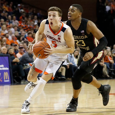 Virginia guard Kyle Guy drives to the basket as...