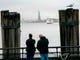 People watch as the Statue of Liberty and Ellis Island ferry transports passengers on Jan. 5, 2019, in New York, as the government shutdown enters its third week. New York state funds are being used to keep the attractions open during the shutdown which has affected National Parks.
