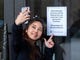 Kunyanatt Chalothorn from Thailand takes a selfie with a closure sign at the entrance to the Smithsonian American Indian Museum in Washington, DC on Jan. 2, 2019.