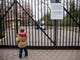 A disappointed young visitor, Asa Hazelwood, 3, pauses at the closed gates to the Smithsonian National Zoo in Washington, DC on Jan. 2, 2019. Asa's mother was unaware of the zoo's closure. The Smithsonian museums and the National Zoo are now closed to visitors during a partial shutdown as Congress and President Trump are at an impasse over funding of Trump's proposed southern border wall.