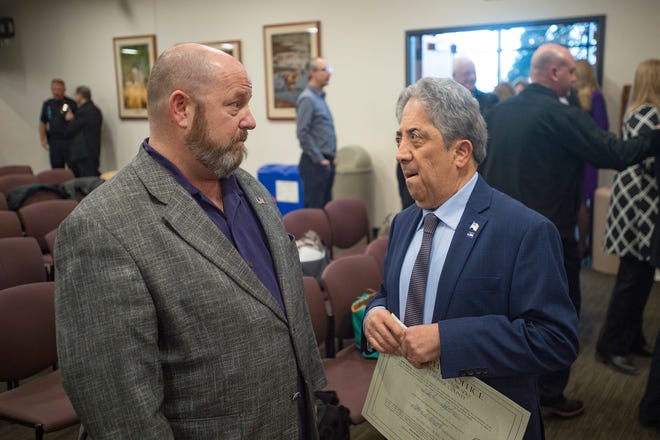 Outgoing Larimer County Commissioner Sean Dougherty talks with John Kefalas, who was sworn in as commissioner at the Larimer County Courthouse Offices Building in Fort Collins on Tuesday.