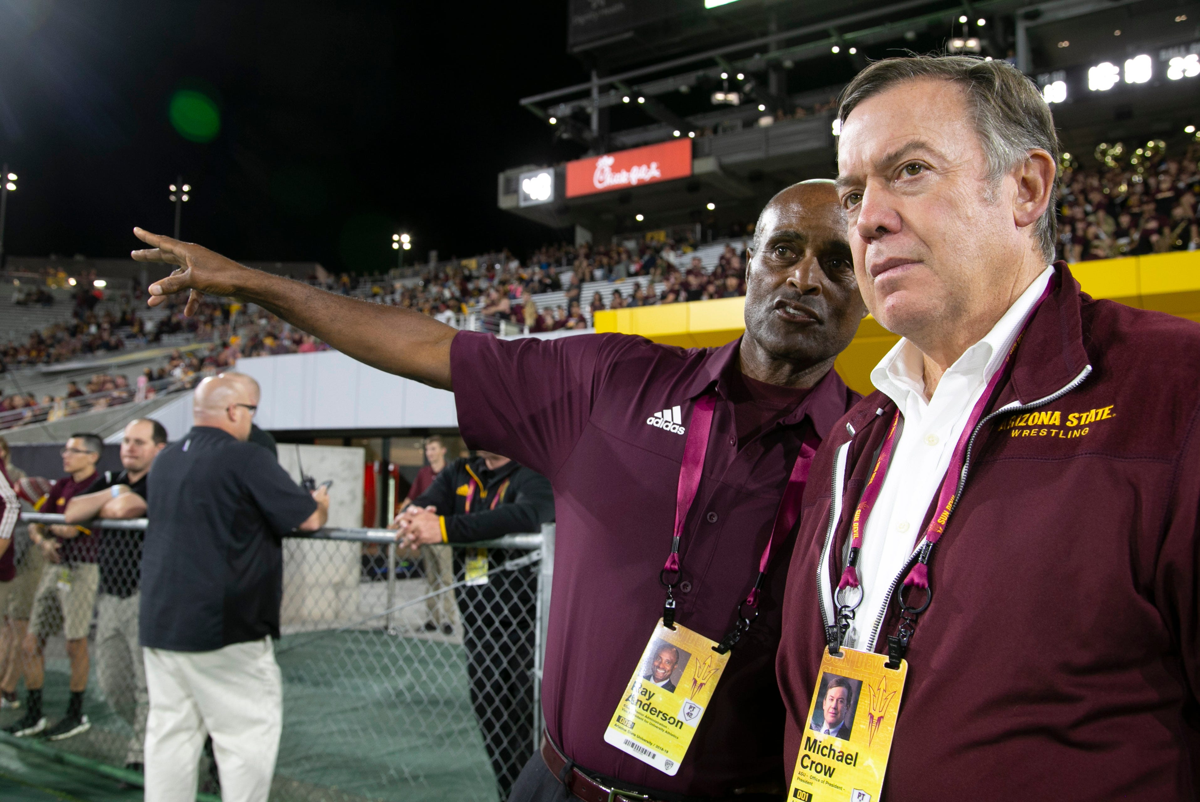 Ray Anderson, vice president for University Athletics (left), and ASU President Michael Crow talk during the ASU and Stanford Pac-12 college football game at Sun Devil Stadium in Tempe on Oct. 18, 2018.