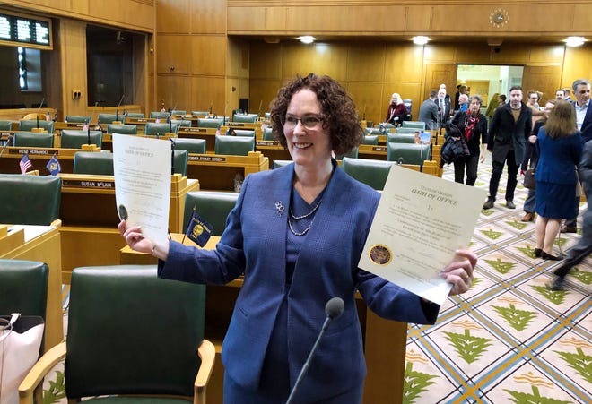 Oregon Labor Commissioner Val Hoyle shows her oath of office after she signed it after her inauguration at the state Capitol in Salem, Ore., Monday, Jan. 7, 2019. The swearing-in of Hoyle marks the first time in Oregon history that most of the five statewide elected executive offices are held by women.