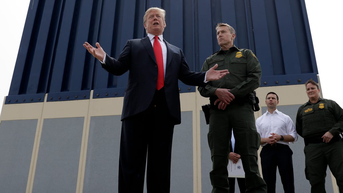 President Donald Trump is pictured speaking during a tour as he reviews border wall prototypes in San Diego, California.