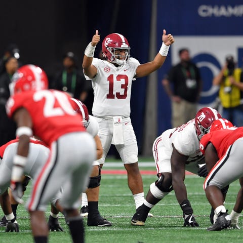 Alabama quarterback Tua Tagovailoa  signals at...