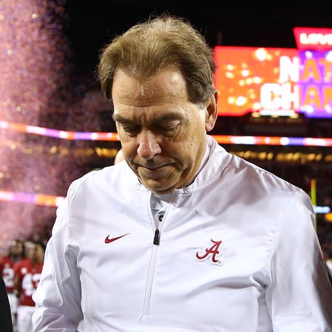 Nick Saban walks off the field after losing to...
