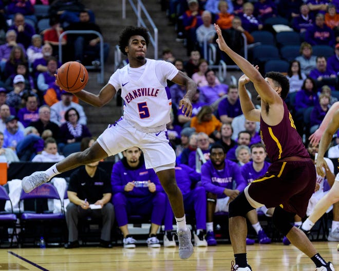 University of Evansville’s Shamar Givance (5) makes a dynamic pass against the Loyola Ramblers at Ford Center in Evansville, Ind., Tuesday, Jan. 8, 2019. The Purple Aces rolled over the Ramblers, 67-48. 