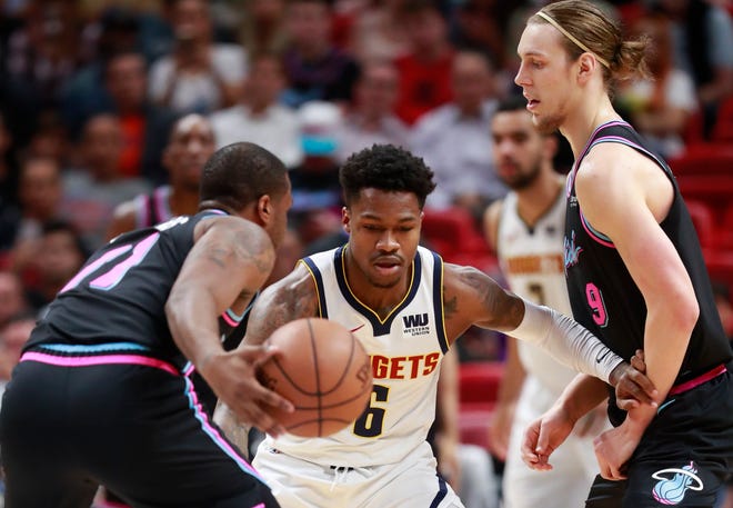Denver Nuggets guard Brandon Goodwin (6) defends against Miami Heat guard Dion Waiters (11) and forward Kelly Olynyk (9) during the first half of against the Heat in Miami on Jan. 8.