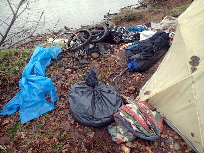 Trash left behind by riverbank campers removed
